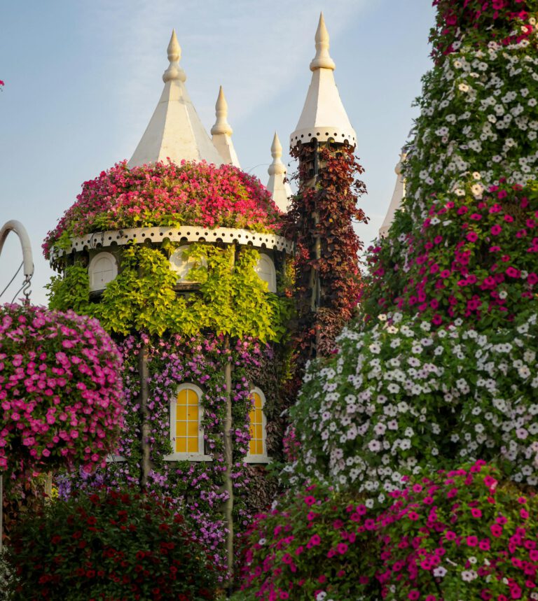 A picturesque castle covered in vibrant blooms amidst a colorful summer garden scene.